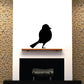 Black bird silhouette wall decal, perched on a ledge