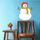 Cozy snowman sticker of smiling snowman wearing red hat and striped scarf