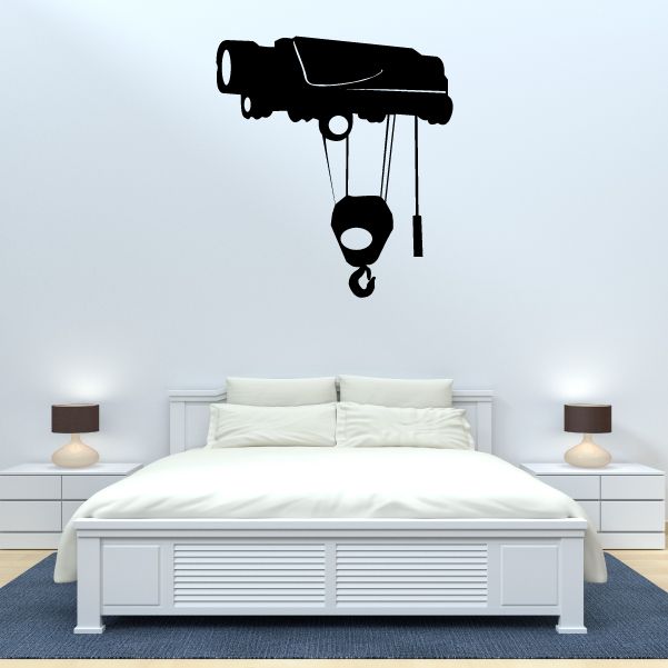 Crane pulley wall decal with black hoist, ropes, and hook above bed