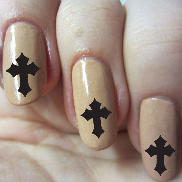 Fingernail sticker set with black cross decals on nude beige nails