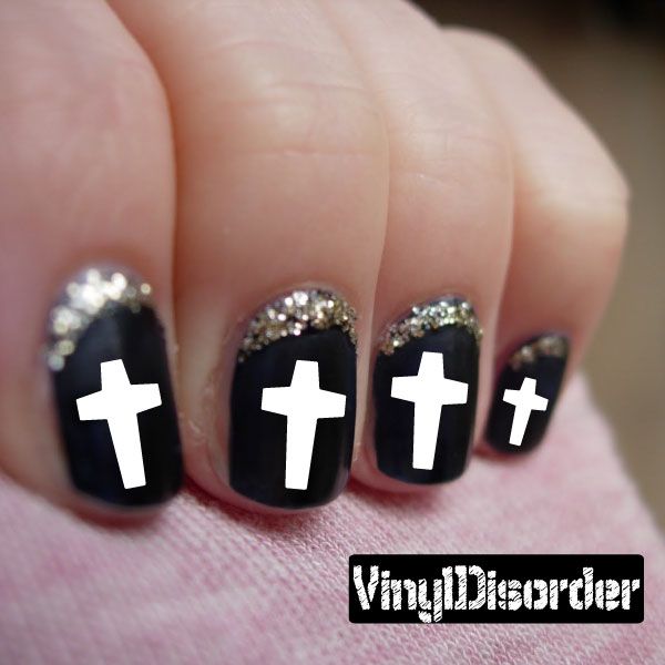 Vinyl nail art stickers with black nail decals, white cross icons and silver glitter tips