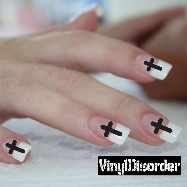 Cross nail art stickers on white nails with black cross decals