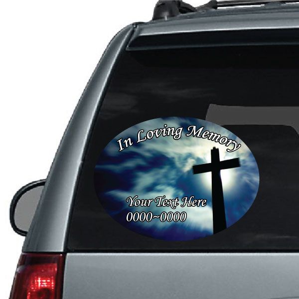 Oval car decal sticker with 'In Loving Memory' text, blue sky, and white cross