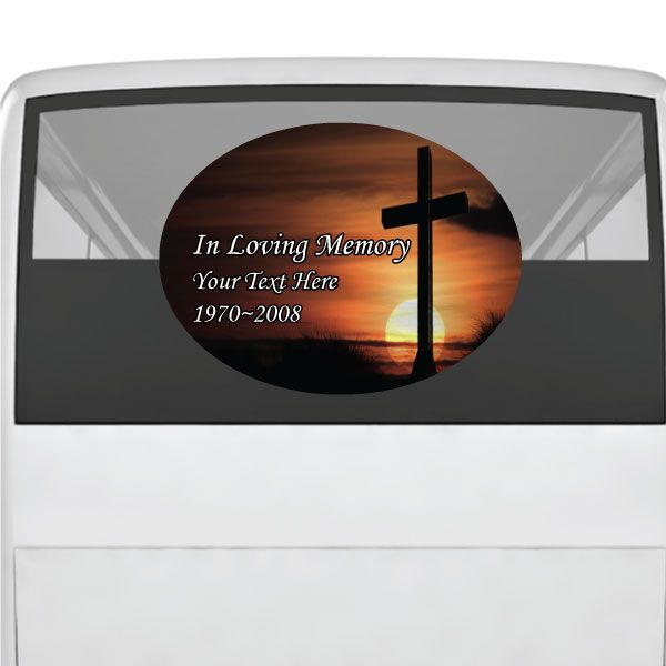 Memorial oval sticker with sunset sky, cross silhouette, and “In Loving Memory” text
