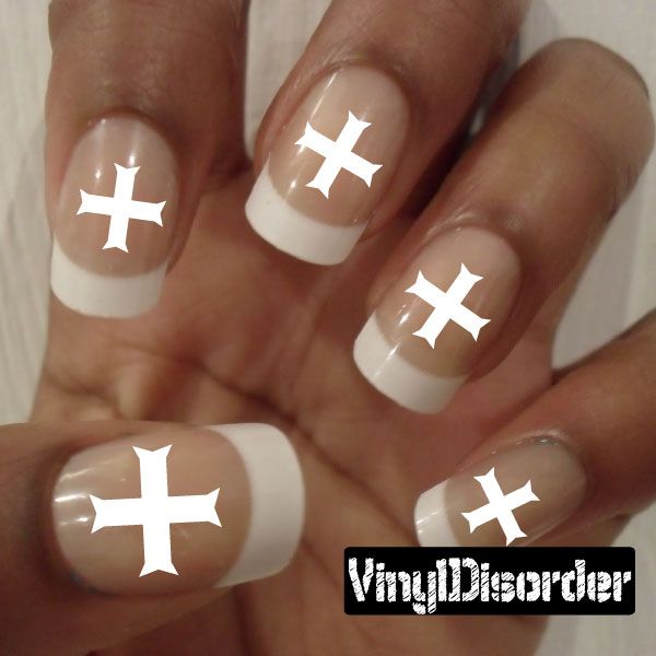 Fingernail art sticker set with white cross decals on natural nude nails