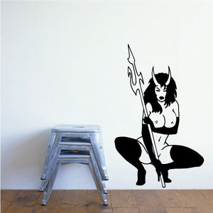 Crouched devil girl decal with pitchfork, black and white figure in boots