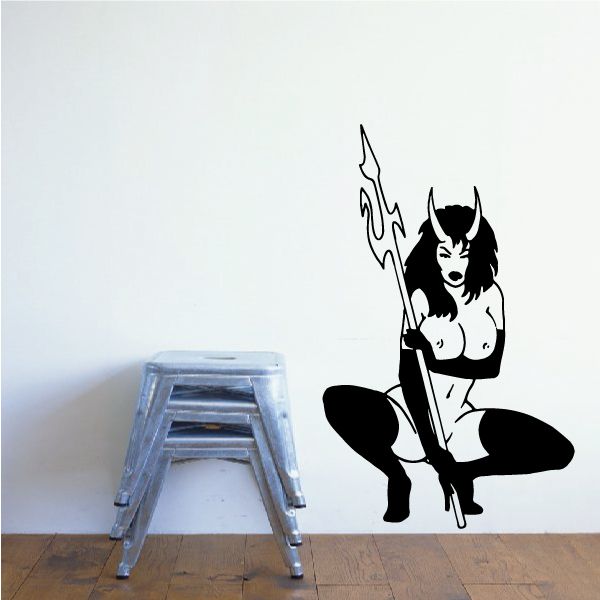 Crouched devil girl decal with pitchfork, black and white figure in boots