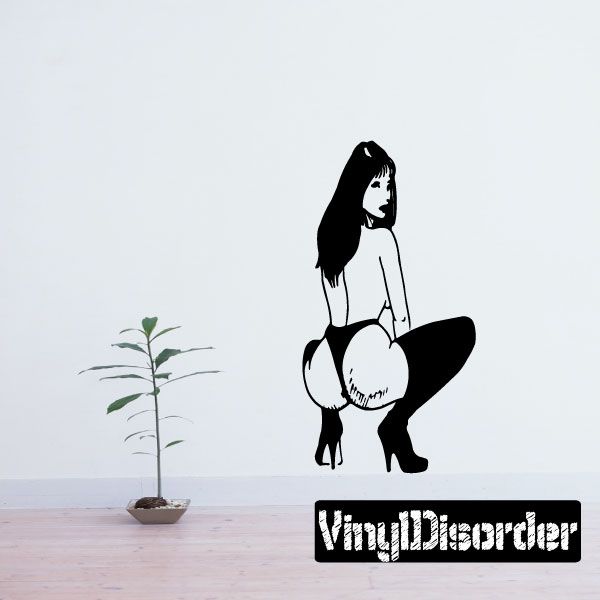 Wall decal of a crouched woman in heels, black-and-white silhouette