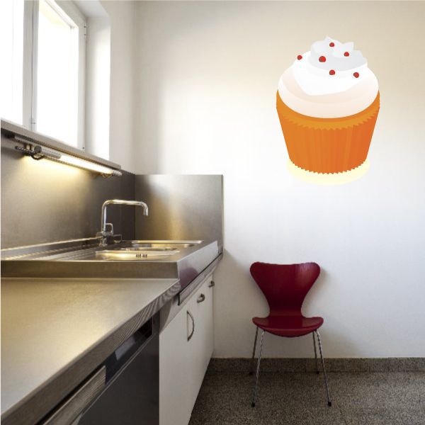 Cupcake sticker with white frosting and orange wrapper, red sprinkles on top