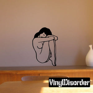 Curled-up nude woman wall decal in black line art, sitting with arms around knees