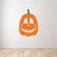 Orange jack-o-lantern decal with curled smile, white eyes, and stitched teeth