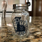 Clear sticker with dark floral emblem on glass jar