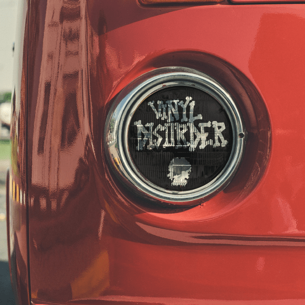 Translucent circular headlight decal with black graphic on lens