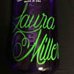 Two-line text decal with green cursive lettering on dark surface