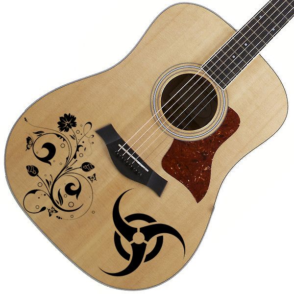 Light wood acoustic guitar with black decorative vinyl art on the body