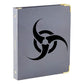 Gray hardback notebook with black biohazard symbol and gold corner hardware