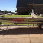 Boat hull lettering with custom registration ID text in red on dark hull