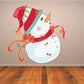 Snowman wall decal with red striped hat, orange carrot nose, and bow accents