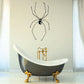 Spider spread decal: black long-legged spider with legs spread on wall.