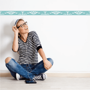 Damask wall decal border with white ornate pattern on teal strip