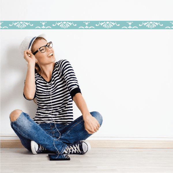 Damask wall decal border with white ornate pattern on teal strip