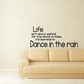 Wall decal text: 'Dance in the rain' with small quote above