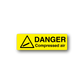 Yellow danger compressed air warning sticker with black hazard triangle and text