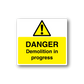 Danger demolition in progress warning sticker with yellow hazard triangle and bold text