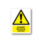 Yellow warning sticker with triangle and “DANGER Reversing Vehicles” text