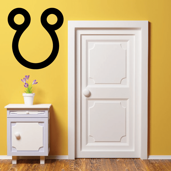 Astrological wall decal with black curving symbol and two round dots