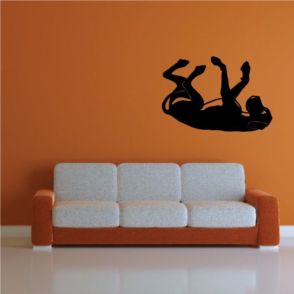 Black Great Dane belly rub silhouette wall decal above a sofa