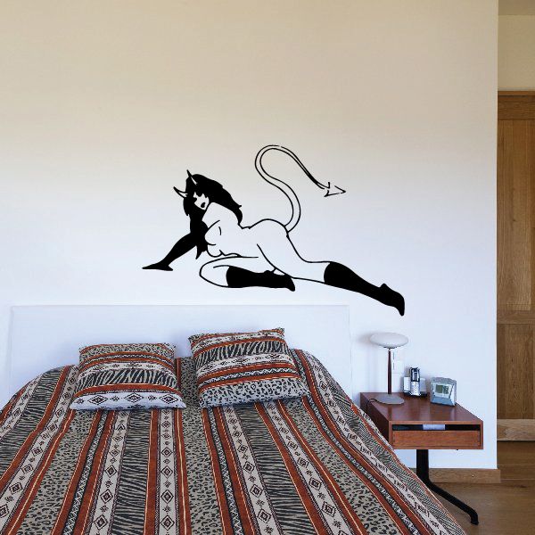 Devil girl lying on side wall decal, black and white silhouette with curled tail.