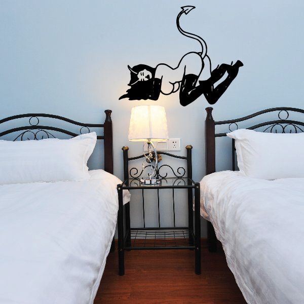 Black devil girl with tail up wall decal, posed with arms out and horns
