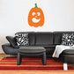 Orange jack-o-lantern face wall decal with green stem and white grin