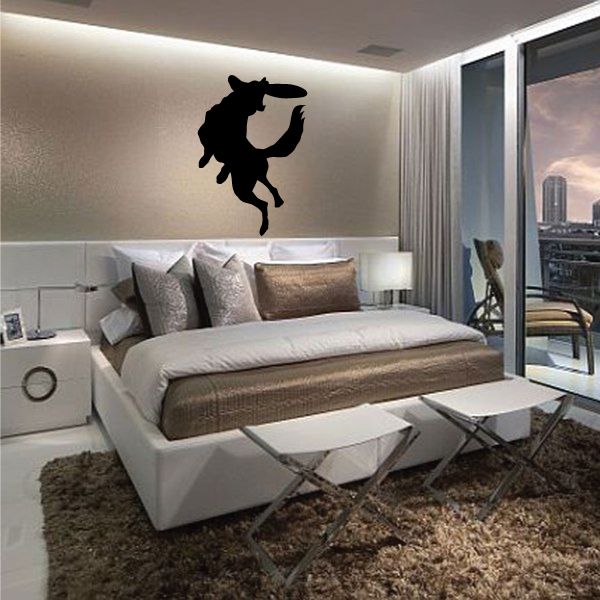 Black dog catching frisbee wall decal silhouette