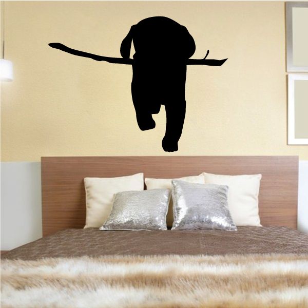 Dog fetching stick wall decal, black silhouette of a running dog holding a stick