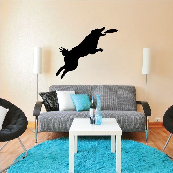 Black dog jumping after frisbee wall decal silhouette