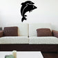 Dolphin couple jumping wall decal, black silhouettes above couch