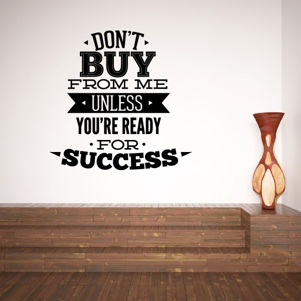 Success quote vinyl wall decal with black lettering on white wall and orange vase