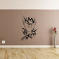 Black dove and thorn decal with geometric outline and wings on a wall