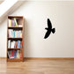 Black dove decal with open wings on a light wall
