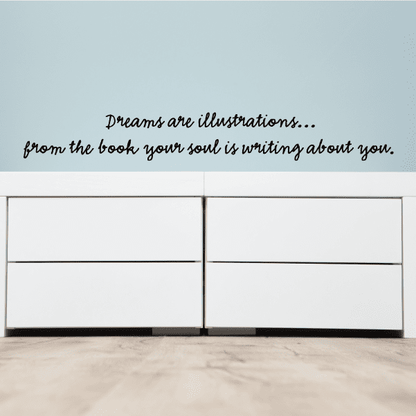 Wall decal with cursive quote text: Dreams are illustrations and your soul is writing.