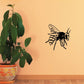Bee wall decal with drifting line-art wings and antennae, black and yellow.