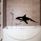 Killer whale wall decal, black silhouette above bathtub in bathroom