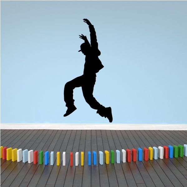 Vinyl wall decal of a black dancer silhouette in mid-jump