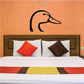 Duck head wall decal with black outline, orange beak and eye on light background