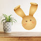 Easter bunny curled-ear sticker, brown-gold rabbit face with ears and whiskers