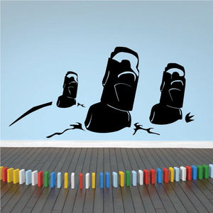 Moai head decal with three black stone silhouettes and carved faces