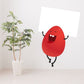 Easter egg holding sign sticker, red cartoon egg character with arms and blank white sign