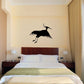 Flying egret silhouette wall decal, black bird design on light wall above bed